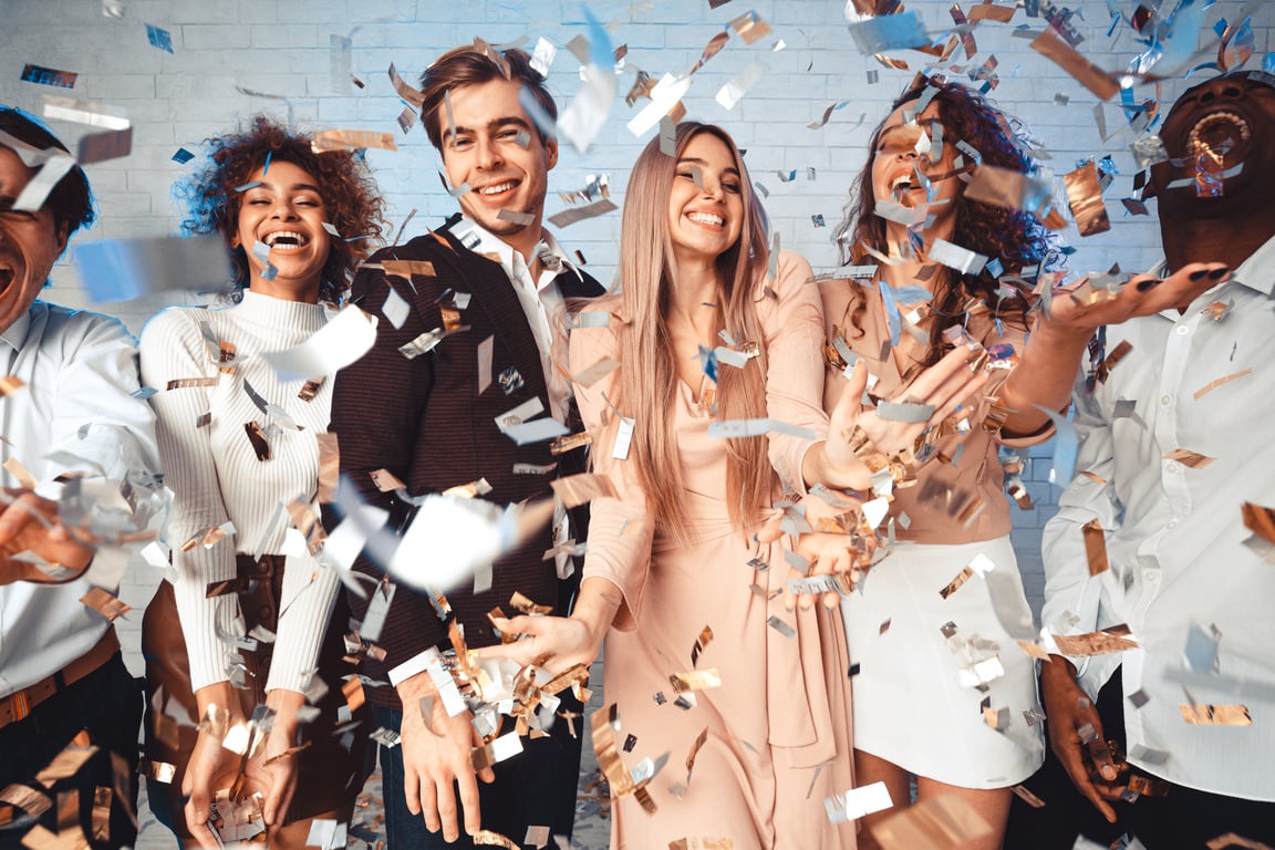 Young People Having Party With Confetti Celebrating Event Indoor